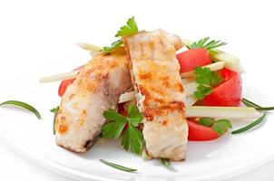Fried filet fish and fresh vegetable salad photo
