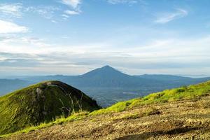 View of Indonesia's mountains with wide green grass photo