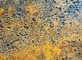 Many rugged holes on the rusty color concrete floor photo