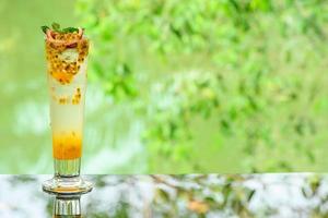 delicious juicy fresh passion fruit on glass table Blurred leaf reflection background photo