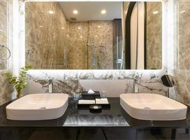 close up modern style interior design of a wash basin on black granit counter in restroom photo