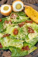 Fresh vegetable salad plate on table background photo