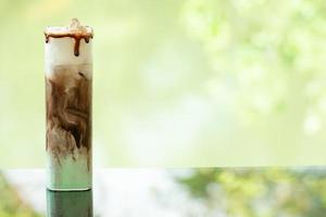 delicious juicy fresh chocolate mint on glass table Blurred leaf reflection background photo