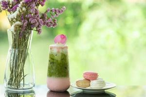 Close up of delicious juicy fresh milk green tea  on glass table Blurred leaf reflection background photo