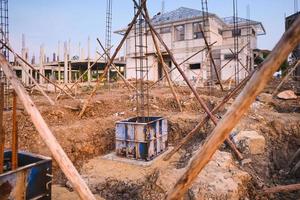 Construction of reinforced concrete foundation with piles to support building weight photo