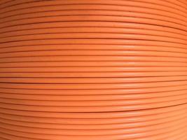 Fiber optic cables are arranged in rolls, Orange background with Fiber optic cables photo