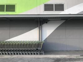 Shopping carts, Many shopping carts are parked near to the wall. photo