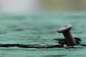 Rusty nail on old wood background with soft focus, Closeup view, Copy space photo