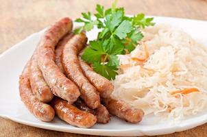 Bavarian fried sausages on sauerkraut photo