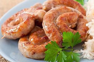 Bavarian fried sausages on sauerkraut photo