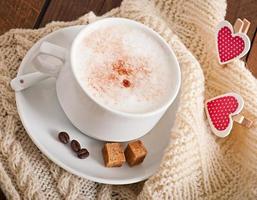 Cup of latte on the old wooden background photo