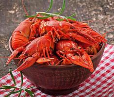 Fresh boiled crawfish on the old wooden background photo