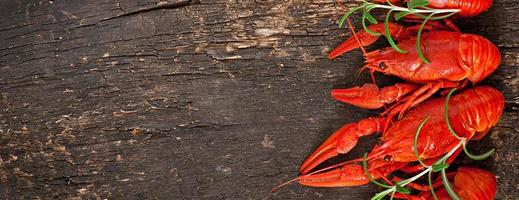 Fresh boiled crawfish on the old wooden background photo