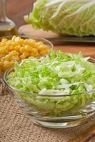 Chinese cabbage salad with sweet corn in a glass bowl photo
