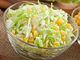 Chinese cabbage salad with sweet corn in a glass bowl photo