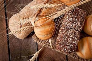 Assortment of baked bread on a wooden table photo