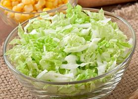 Chinese cabbage salad with sweet corn in a glass bowl photo