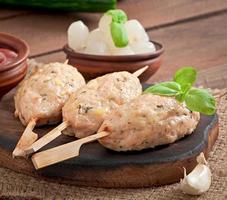 Kebab of minced chicken with dill and parsley photo