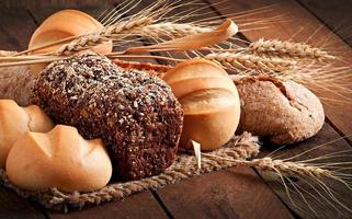 Assortment of baked bread on a wooden table photo