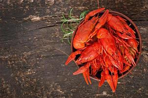 Fresh boiled crawfish on the old wooden background photo