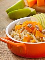 Oatmeal with pumpkin, apples, nuts and honey photo