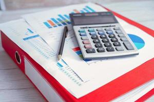 Calculator on chart and graph spreadsheet paper. Finance developmen photo