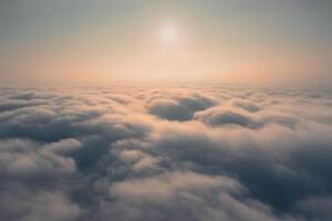 Morning sun rises above the clouds - aerial view