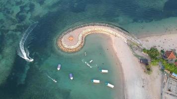 vista aerea del drone della spiaggia di sanur, bali con tradizionali barche da pesca balinesi incredibile oceano blu. video