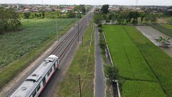 Aerial View of Passenger Train Passing by a Rail in Yogyakarta Indonesia video