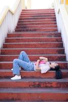 Student young girl lay down on stairs at shool. photo