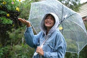 Smile young girl having fun in rainy. photo