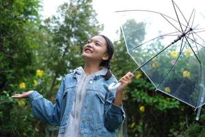 Smile young girl having fun in rainy. photo