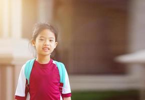 Big kid with backpack go back to school in PE uniform photo