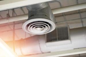 Air conditioner opening on loft style ceiling photo