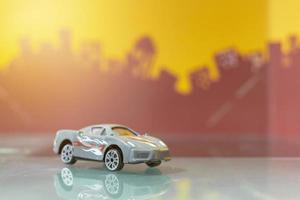 Bangkok, Thailand, Feb 22,2022-Grey racer car toy selective focus on blur city background photo