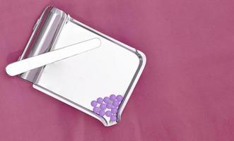 pharmacy tray with purple pills on purple  medical background photo