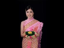 Attractive Thai woman dressed in traditional Thai clothes holds a flower basket photo