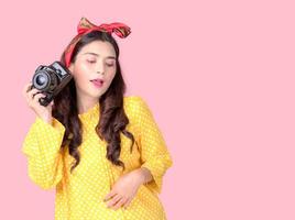 Beautiful and charming women in retro style outfits, Holding a film camera photo