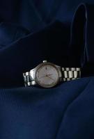 Elegant wrist watch closeup on blue background photo