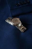 Elegant wrist watch on blue jacket photo