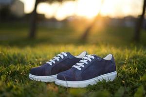 Blue sport woman shoes. Spring footwear at the park photo