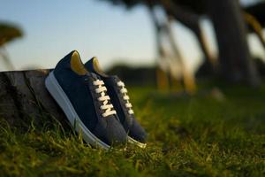 Blue female sport shoes on the park background photo