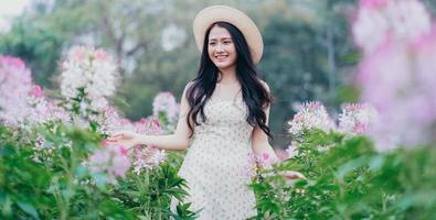 Portrait of young Asian woman at flowers field photo