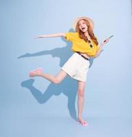 Portrait of young Asian girl on blue background, summer vacation concept photo