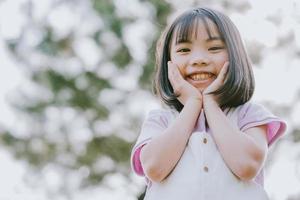 Portrait of Asian little girl playing in the park photo