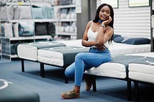 Portrait of a beautiful african american woman sitting in the store. photo