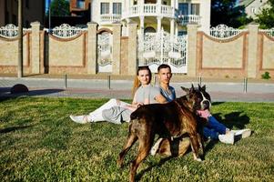 Couple in love with two dogs pit bull terrier on a walk. photo