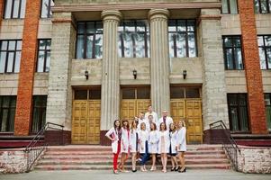 Cool young doctors or medical workers posing outside the hospital or clinique. photo