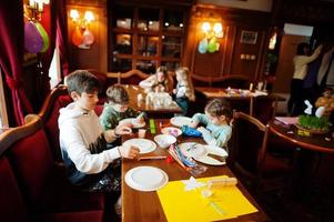 Preparing to Easter concept. Kids making by hands bunny and eggs. photo