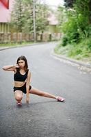 Sport girl at sportswear exercising in a green park and training at nature. A healthy lifestyle. photo